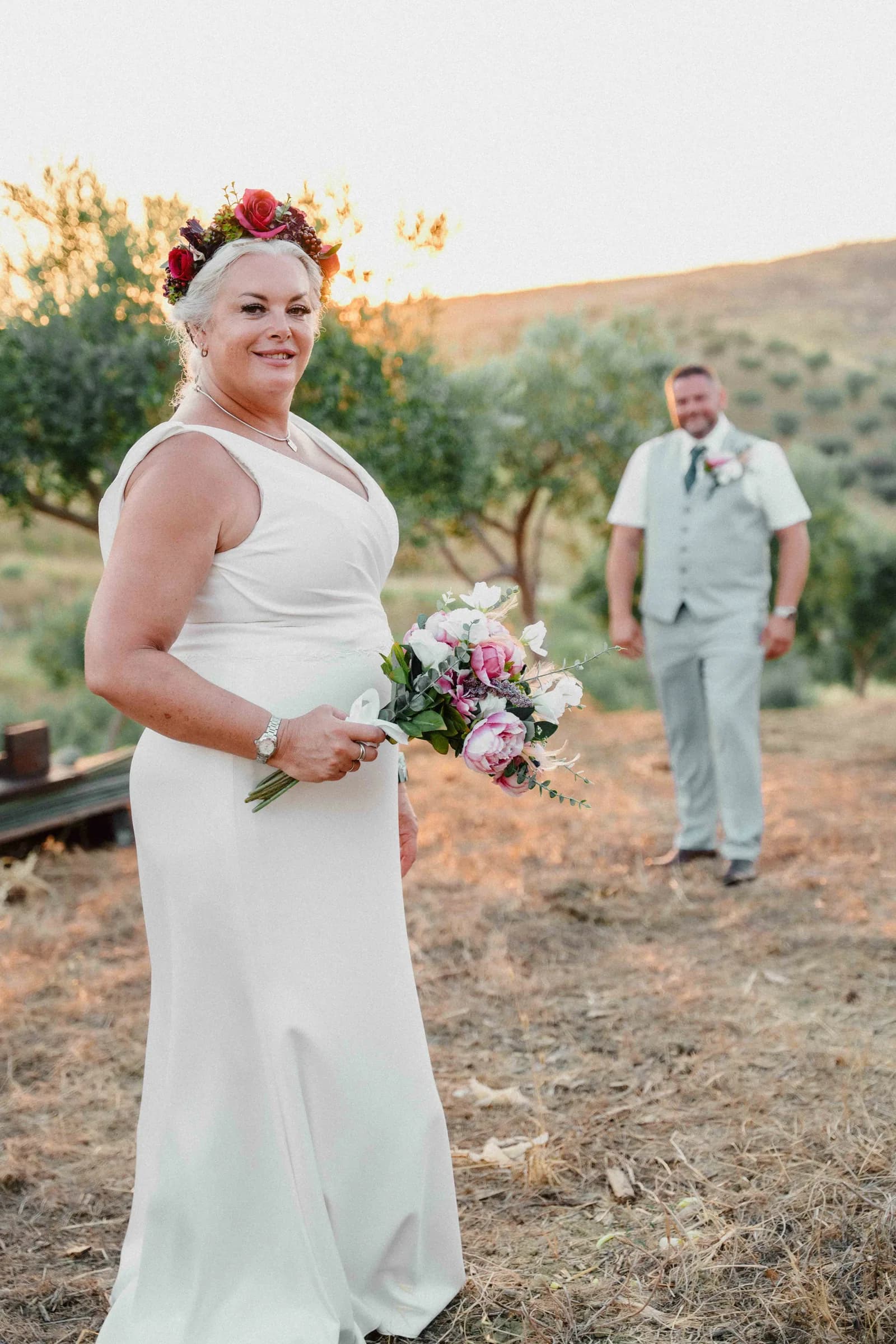 The couple standing quietly together in an open Sicilian field
