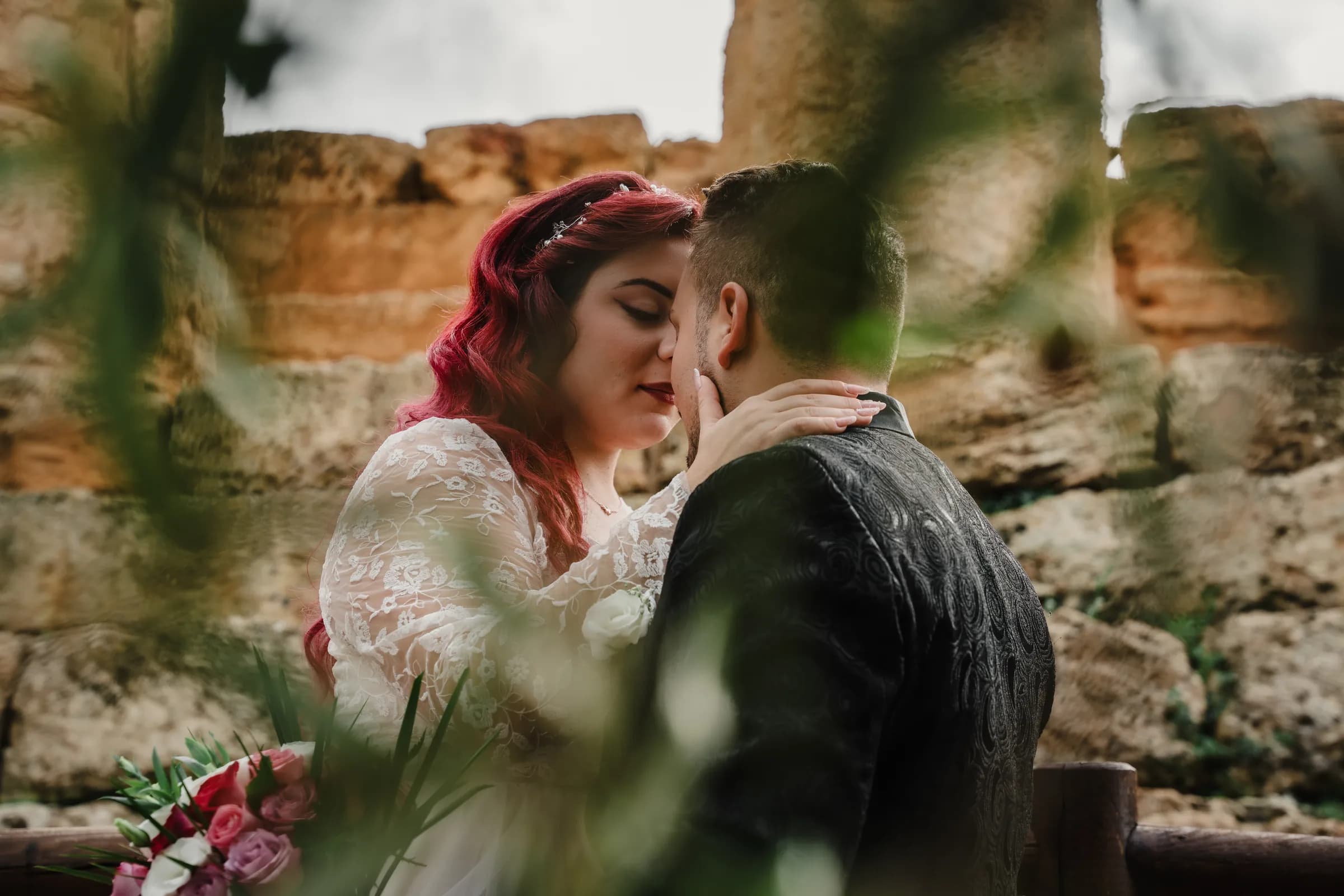A couple glimpsed through foliage, close together