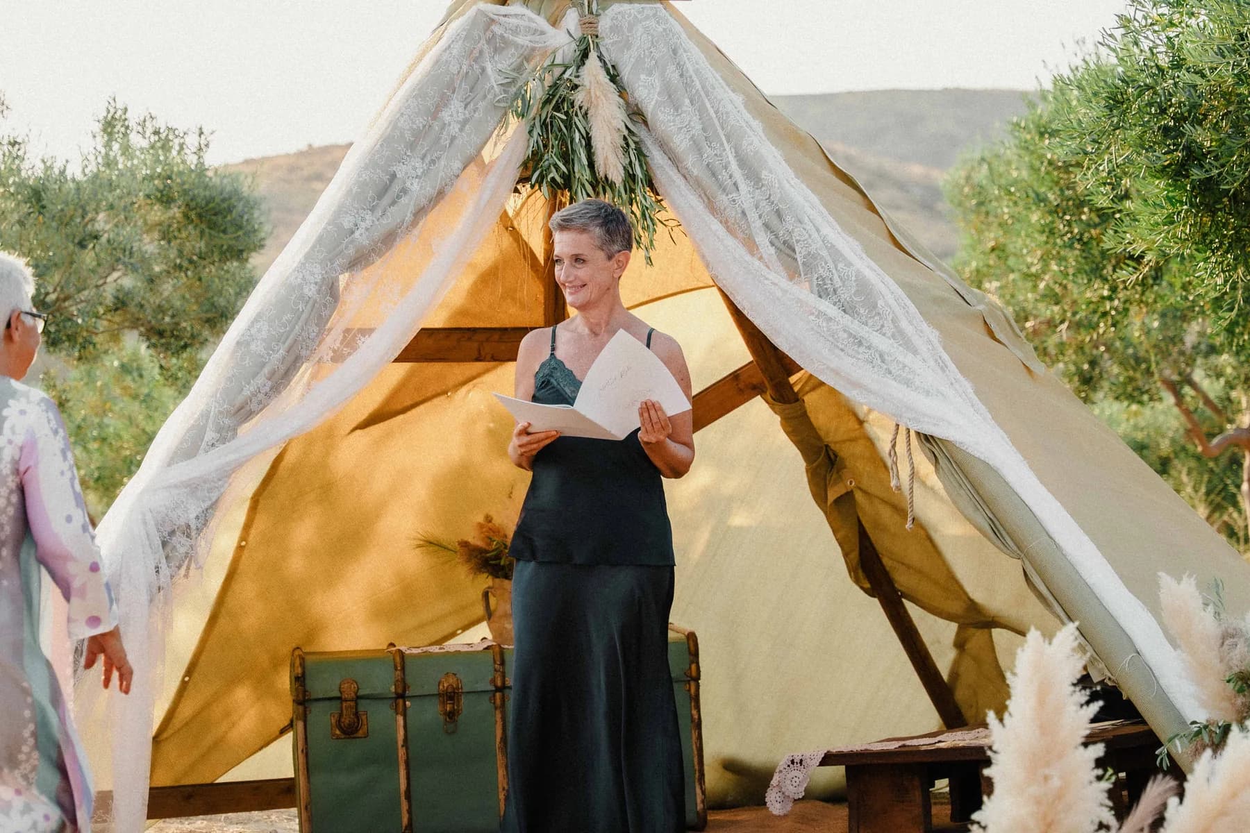 Cristiana Romano leading a ceremony at an olive-grove setting